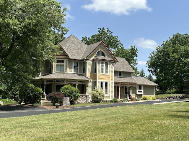823 E Brandybrook Rd, Wales, WI 53183 - victorian-style house with a porch, a front yard, and roof with shingles