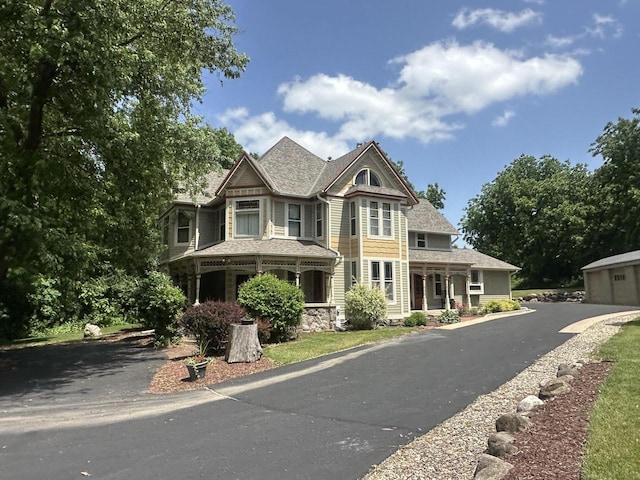 823 E Brandybrook Rd, Wales, WI 53183 - victorian-style house featuring a garage, stone siding, and roof with shingles