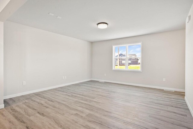 N6220 Blarney Stone Dr Unit 53, Albany, WI 53520 - spare room featuring wood finished floors and baseboards