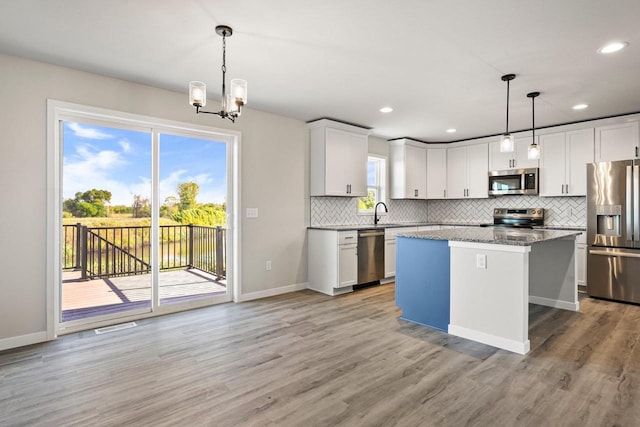 N6220 Blarney Stone Dr Unit 53, Albany, WI 53520 - kitchen featuring stainless steel appliances, tasteful backsplash, light wood finished floors, a kitchen island, and recessed lighting