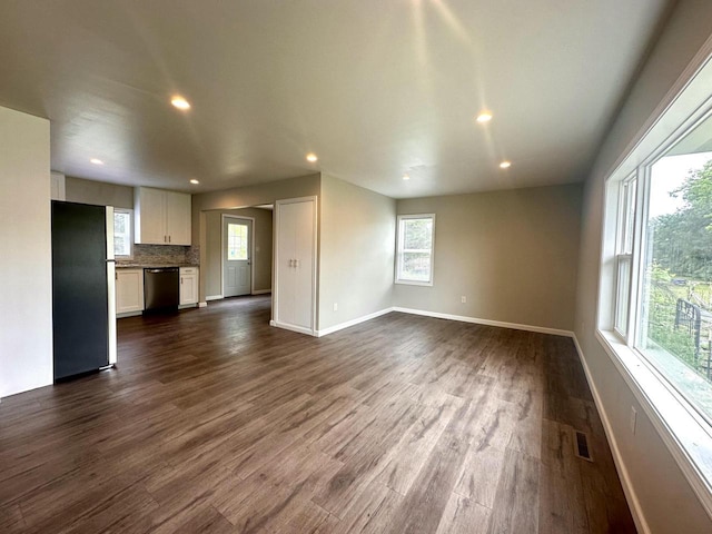 6315 245th Ave, Salem, WI 53168 - unfurnished living room featuring healthy amount of natural light, recessed lighting, and dark wood-type flooring