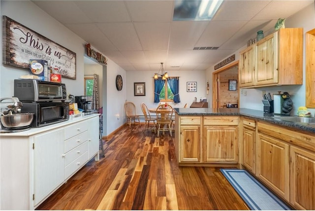 1674 W White Ash Dr, Balsam Lake, WI 54810 - kitchen featuring a paneled ceiling, dark wood-style floors, a peninsula, a chandelier, and black microwave