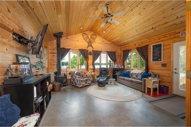 1674 W White Ash Dr, Balsam Lake, WI 54810 - living room featuring wooden walls, a wood stove, vaulted ceiling, wooden ceiling, and concrete floors