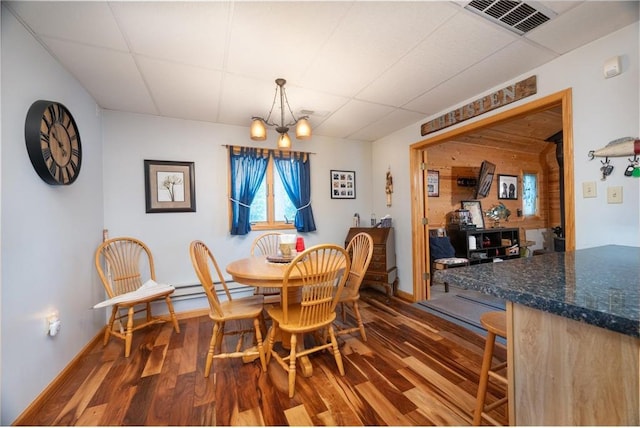 1674 W White Ash Dr, Balsam Lake, WI 54810 - dining area featuring wood finished floors, a drop ceiling, and a chandelier