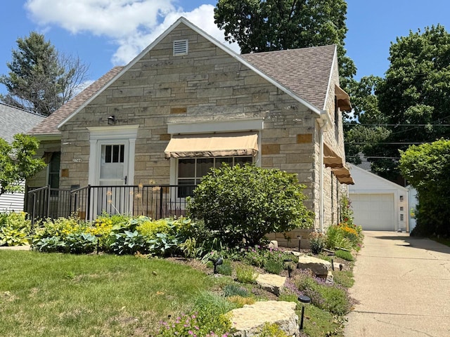 2744 N Lefeber Ave, Wauwatosa, WI 53210 - view of front of property featuring stone siding, roof with shingles, and a garage