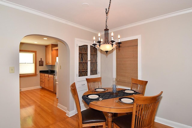 2744 N Lefeber Ave, Wauwatosa, WI 53210 - dining area with arched walkways, light wood-style flooring, a chandelier, and crown molding