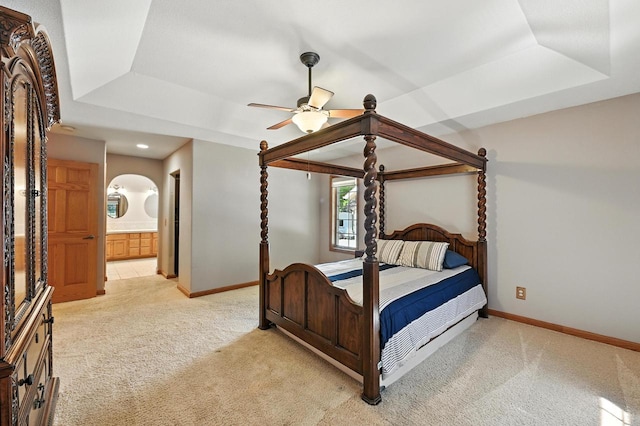 520 Bayberry Ln, Slinger, WI 53086 - bedroom featuring light colored carpet, a tray ceiling, ensuite bathroom, and ceiling fan