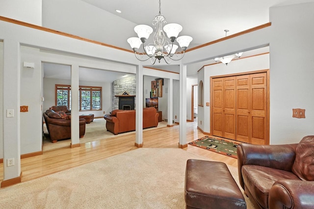 520 Bayberry Ln, Slinger, WI 53086 - carpeted living area with wood finished floors, a chandelier, and a stone fireplace