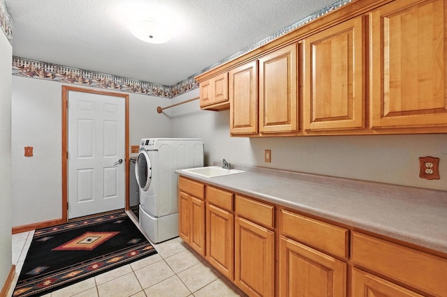 520 Bayberry Ln, Slinger, WI 53086 - laundry room with cabinet space, light tile patterned floors, a textured ceiling, and washer and dryer