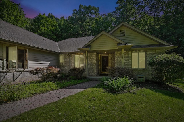 520 Bayberry Ln, Slinger, WI 53086 - view of front of home with brick siding, a yard, and a porch