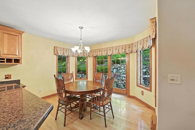 520 Bayberry Ln, Slinger, WI 53086 - dining area with a chandelier and light wood-type flooring