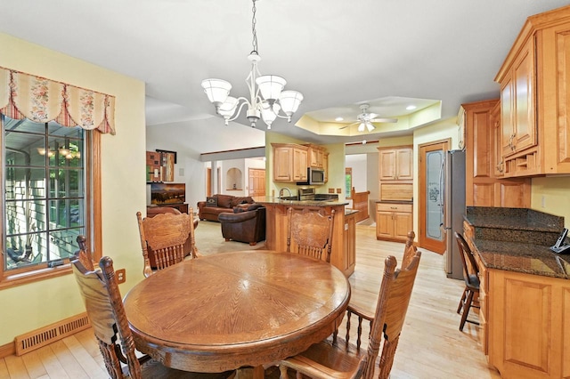 520 Bayberry Ln, Slinger, WI 53086 - dining room with light wood-style floors, a ceiling fan, a chandelier, and healthy amount of natural light