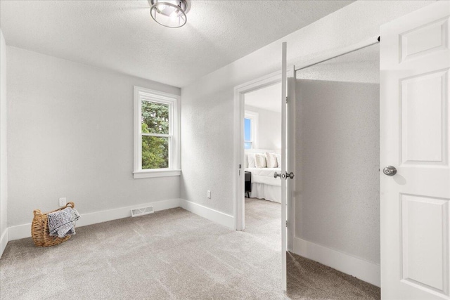 5306 Hillcrest Dr, Allenton, WI 53002 - unfurnished bedroom featuring carpet and a textured ceiling