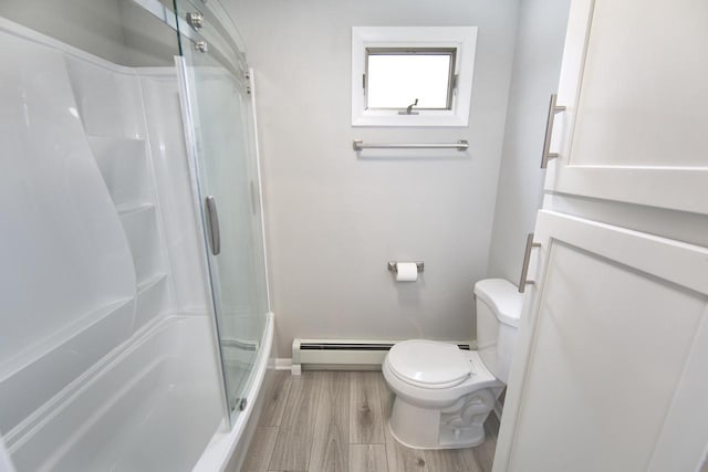 N88W17123 Elmwood Dr, Menomonee Falls, WI 53051 - bathroom with baseboard heating, a shower with door, and wood finished floors