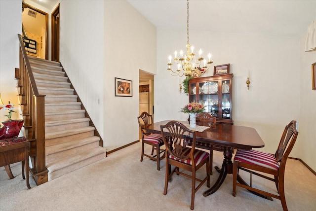 1075 E Murray Ln, Hubertus, WI 53033 - dining space featuring light carpet, stairs, a chandelier, and a high ceiling