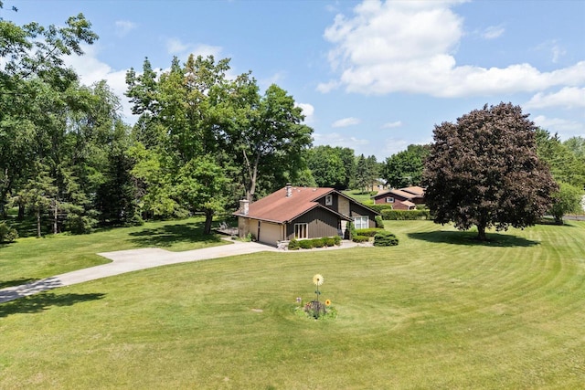 1075 E Murray Ln, Hubertus, WI 53033 - view of green lawn with concrete driveway and a garage