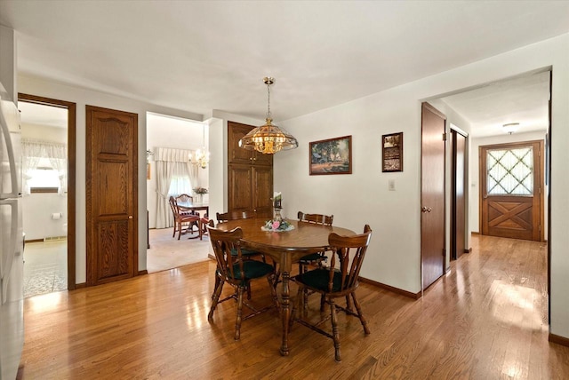 1075 E Murray Ln, Hubertus, WI 53033 - dining space featuring a chandelier and light wood-style floors