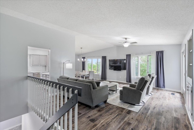 615 N Peach Ave, Marshfield, WI 54449 - living room featuring wood finished floors, healthy amount of natural light, lofted ceiling, a textured ceiling, and a ceiling fan