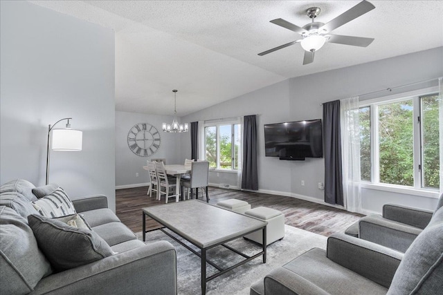 615 N Peach Ave, Marshfield, WI 54449 - living room featuring a chandelier, wood finished floors, ceiling fan, lofted ceiling, and a textured ceiling