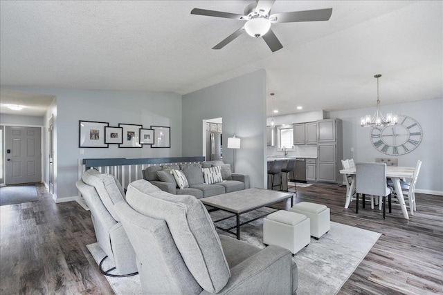 615 N Peach Ave, Marshfield, WI 54449 - living area featuring vaulted ceiling, a chandelier, dark wood-style flooring, and ceiling fan