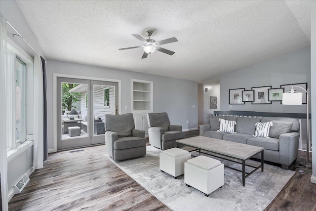 615 N Peach Ave, Marshfield, WI 54449 - living room featuring a textured ceiling, a ceiling fan, wood finished floors, and built in features