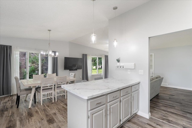 615 N Peach Ave, Marshfield, WI 54449 - kitchen with wood finished floors, plenty of natural light, a chandelier, a peninsula, and lofted ceiling