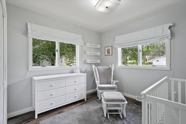 615 N Peach Ave, Marshfield, WI 54449 - bedroom with multiple windows, dark wood finished floors, and a nursery area