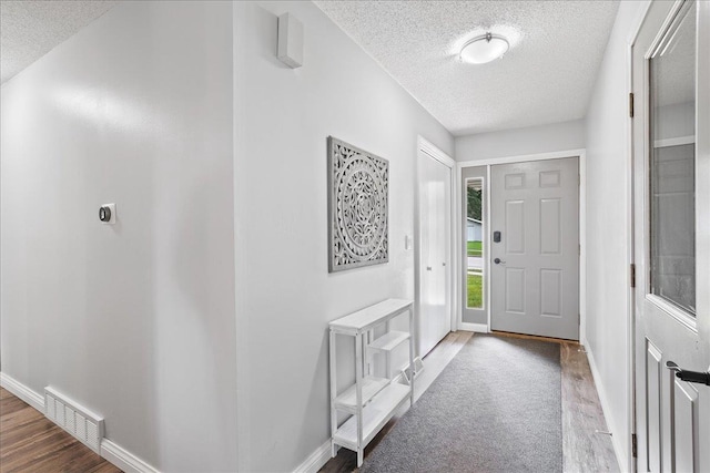 615 N Peach Ave, Marshfield, WI 54449 - entrance foyer with a textured ceiling and wood finished floors