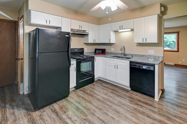 5716 Sauk Ln, Mcfarland, WI 53558 - kitchen featuring black appliances, under cabinet range hood, a ceiling fan, and light wood-type flooring
