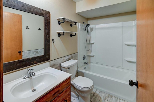 5716 Sauk Ln, Mcfarland, WI 53558 - bathroom with vanity, bathtub / shower combination, tile walls, and wood finished floors
