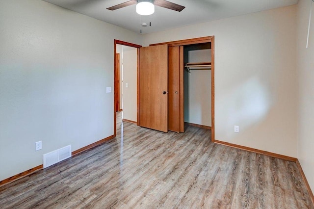 5716 Sauk Ln, Mcfarland, WI 53558 - unfurnished bedroom featuring wood finished floors, a closet, and ceiling fan