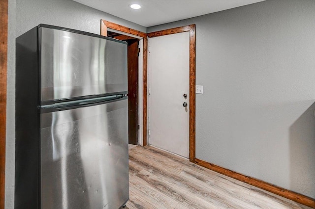 5716 Sauk Ln, Mcfarland, WI 53558 - kitchen with freestanding refrigerator, light wood finished floors, recessed lighting, and a textured wall