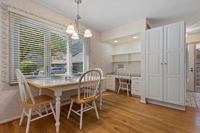 36 Stonewood Ct Unit 36, Wind Point, WI 53402 - dining space featuring light wood-type flooring, a desk, and a chandelier