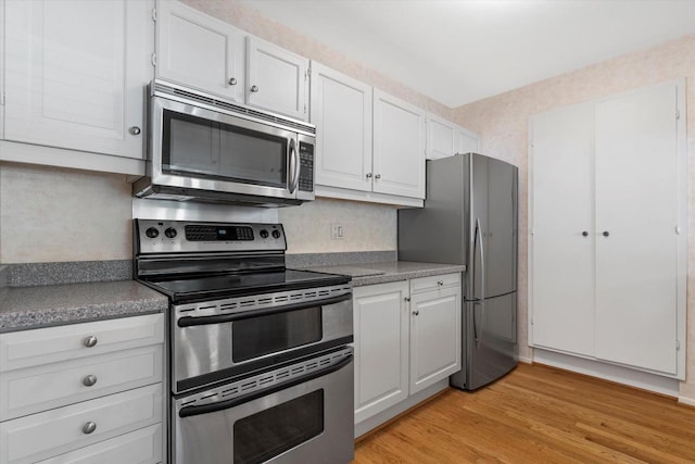 36 Stonewood Ct Unit 36, Wind Point, WI 53402 - kitchen featuring appliances with stainless steel finishes, light wood-type flooring, and white cabinets