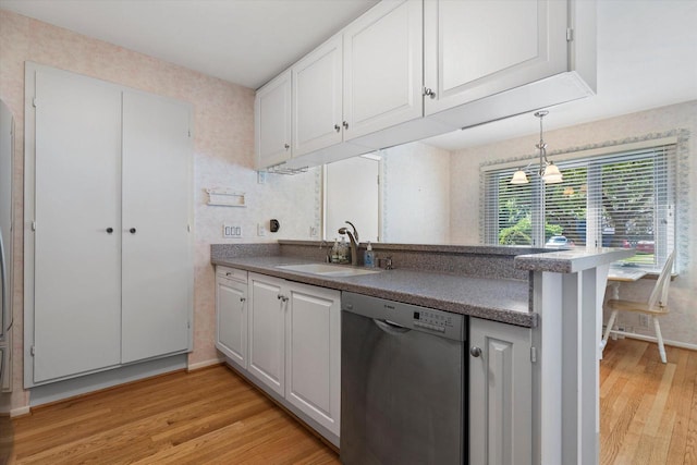 36 Stonewood Ct Unit 36, Wind Point, WI 53402 - kitchen with stainless steel dishwasher, light wood finished floors, white cabinets, a peninsula, and decorative light fixtures