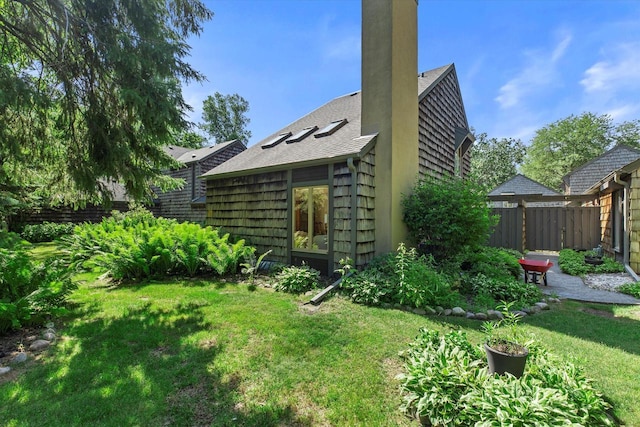 36 Stonewood Ct Unit 36, Wind Point, WI 53402 - back of property with a chimney, roof with shingles, and a patio area