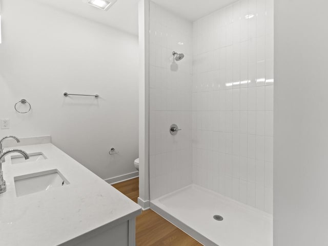 9352 S Alder Pl Unit 105, Oak Creek, WI 53154 - bathroom with tiled shower, double vanity, and wood finished floors