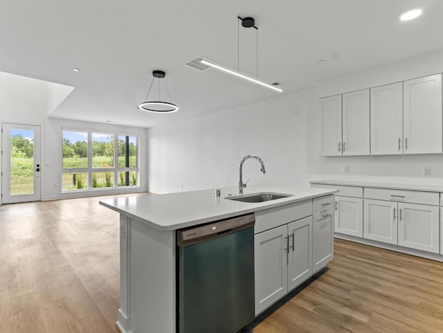 9352 S Alder Pl Unit 105, Oak Creek, WI 53154 - kitchen with dishwasher, open floor plan, a kitchen island with sink, light countertops, and light wood-style floors