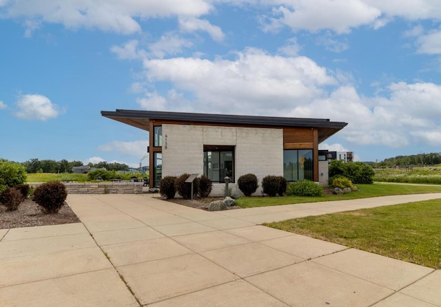 9352 S Alder Pl Unit 105, Oak Creek, WI 53154 - view of property exterior featuring concrete driveway and a lawn
