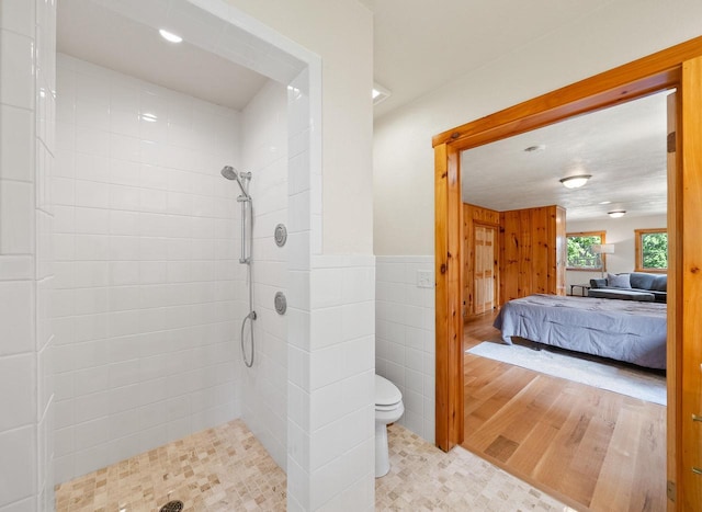 N3245 Walnut Rd, Lake Geneva, WI 53147 - ensuite bathroom with a tile shower, wainscoting, tile walls, and recessed lighting