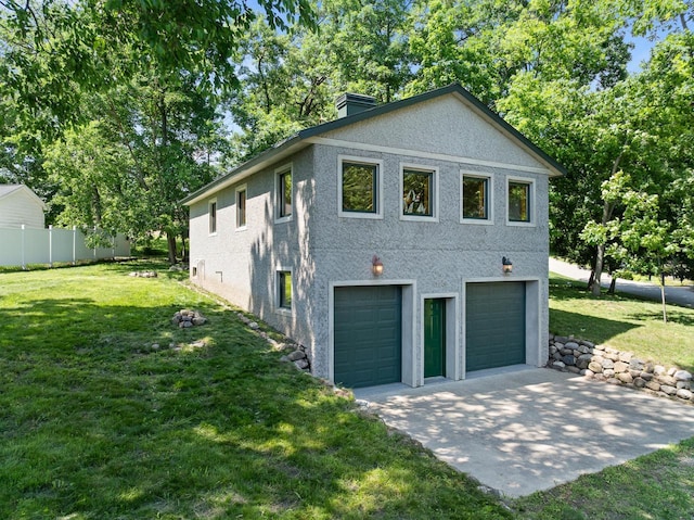 N3245 Walnut Rd, Lake Geneva, WI 53147 - view of side of home with stucco siding, a chimney, and driveway