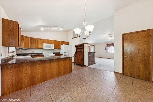 911 Park Cir, Union Grove, WI 53182 - kitchen featuring white appliances, a peninsula, brown cabinetry, a chandelier, and high vaulted ceiling