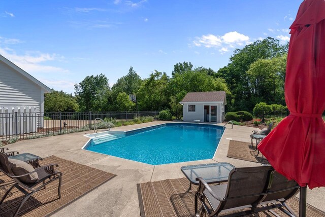 1948 Field Cliffe Dr, Richfield, WI 53076 - view of swimming pool featuring a patio, an outbuilding, and view of scattered trees