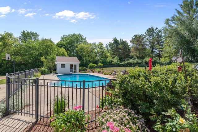 1948 Field Cliffe Dr, Richfield, WI 53076 - view of swimming pool with view of scattered trees, an outbuilding, and a patio