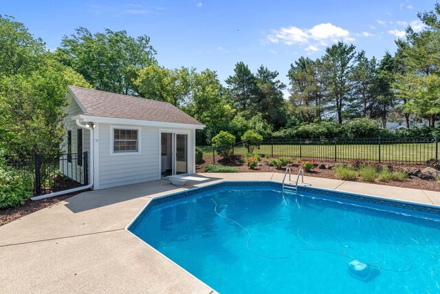 1948 Field Cliffe Dr, Richfield, WI 53076 - view of swimming pool with a storage structure, an outbuilding, view of scattered trees, and a patio