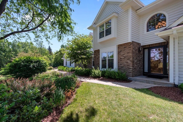 1948 Field Cliffe Dr, Richfield, WI 53076 - view of property exterior with brick siding and a lawn