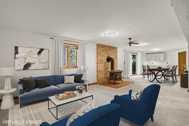 2806 Mckenna Blvd, Madison, WI 53719 - carpeted living area with a wood stove, plenty of natural light, and a ceiling fan