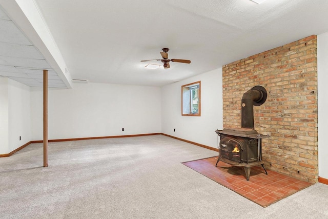 2806 Mckenna Blvd, Madison, WI 53719 - unfurnished living room featuring carpet floors, a ceiling fan, and a wood stove
