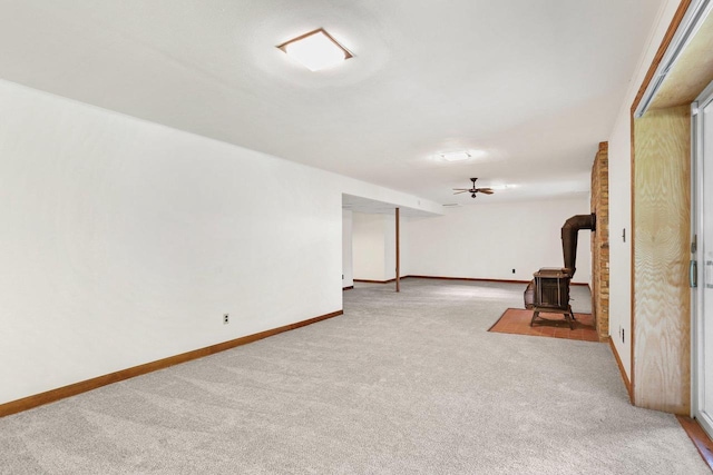 2806 Mckenna Blvd, Madison, WI 53719 - carpeted empty room featuring a wood stove and baseboards