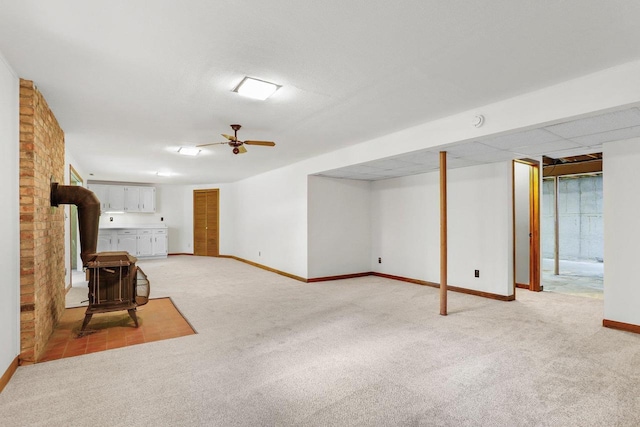 2806 Mckenna Blvd, Madison, WI 53719 - unfurnished living room featuring a wood stove, light carpet, and ceiling fan